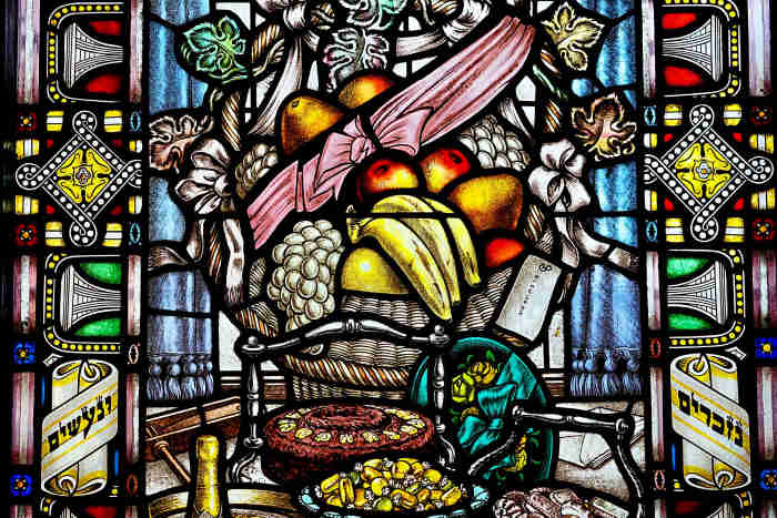 Stained glass window depicting bountiful fruits as rewards from bible app