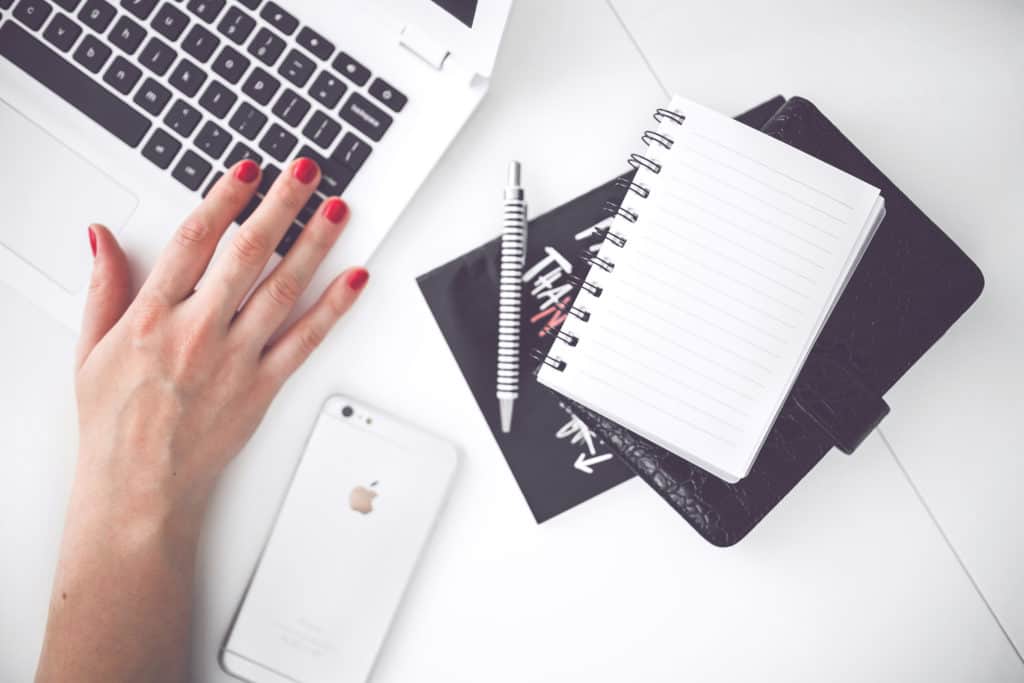 woman-hand-smartphone-desk