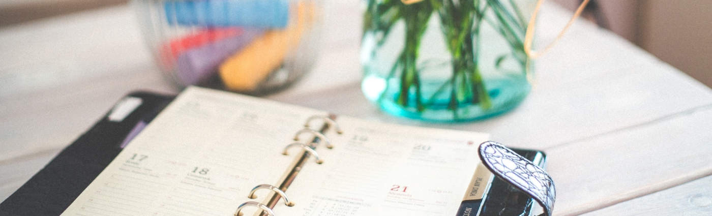 time management techniques with leather day planner on table