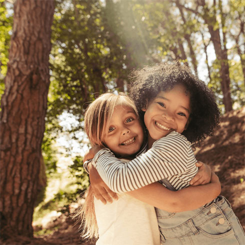 Photo of two friends,hugging and smiling