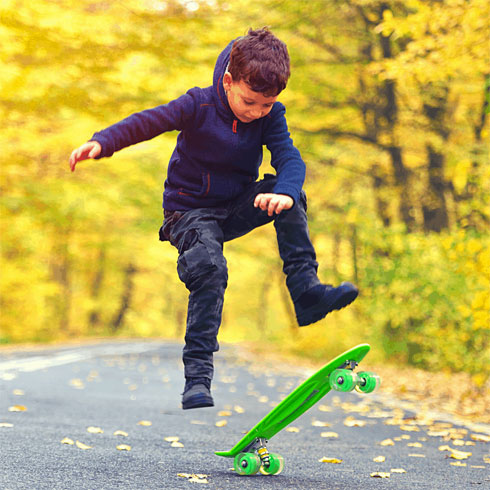  Child demonstrating competence with skateboard. 