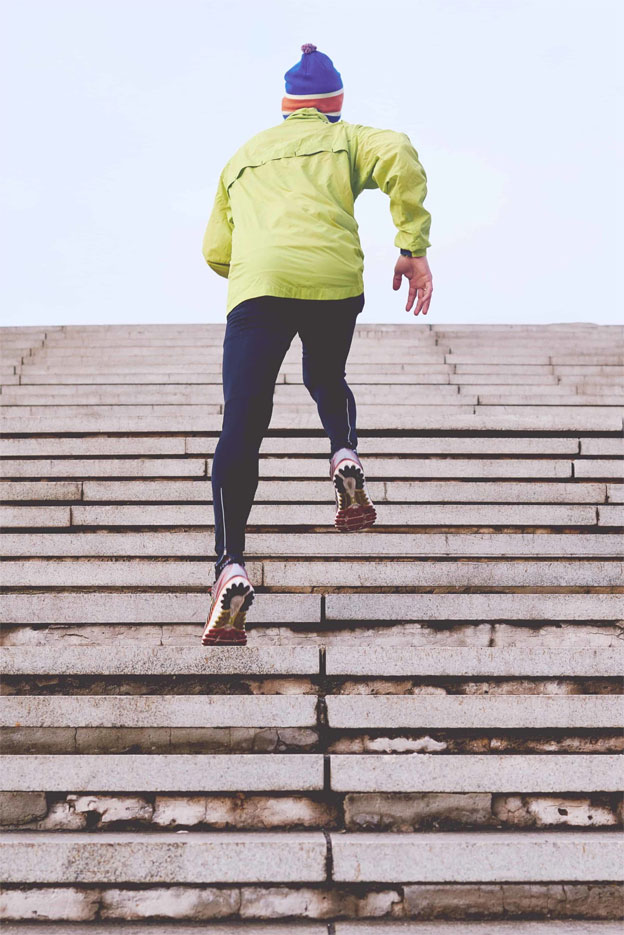 Super-motivated man running up a daunting number of stadium steps.