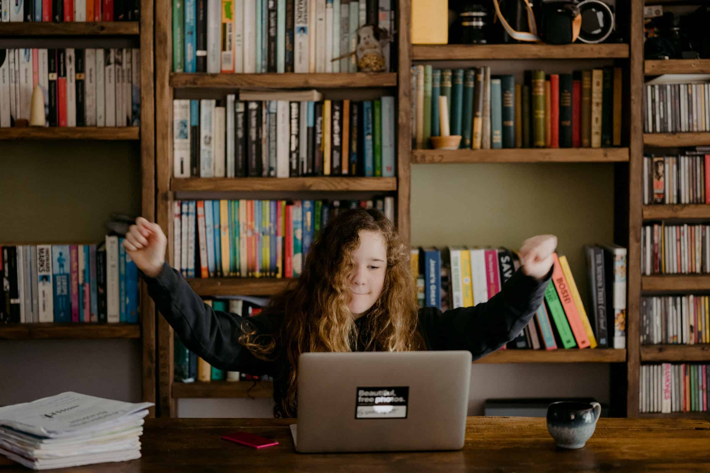 Motivated student is excited to have finished schoolwork.