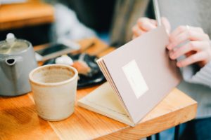 Woman writing introspective thoughts in journal