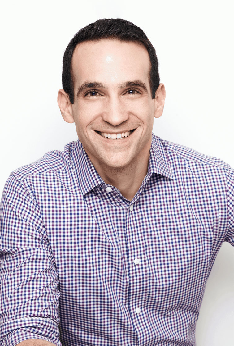 Headshot of Nir Eyal smiling in front of white background